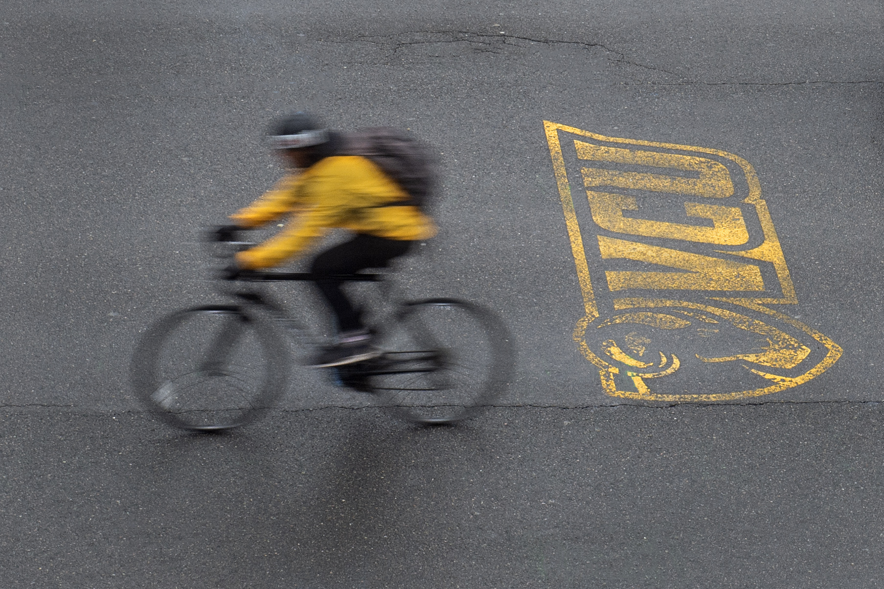 Person on bike with VCU logo painted on the pavement